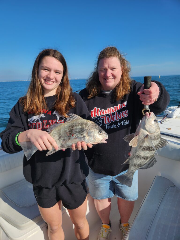 Mom and daughter holding black drum on the Fish Finder I