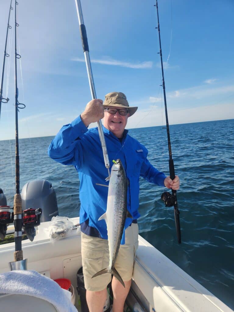 Holding the First King mackerel of the season caught on Fish Finder 1 out of murrells inlet