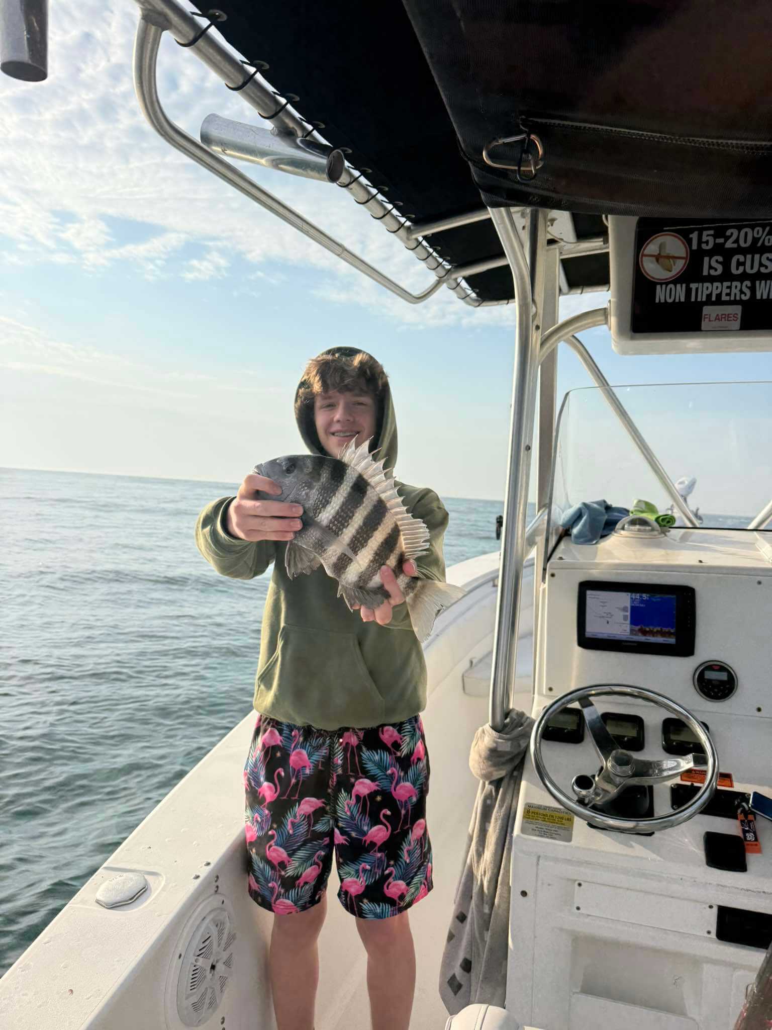 Young angler holding a sheepshead fish on a family fishing charter trip in Florida