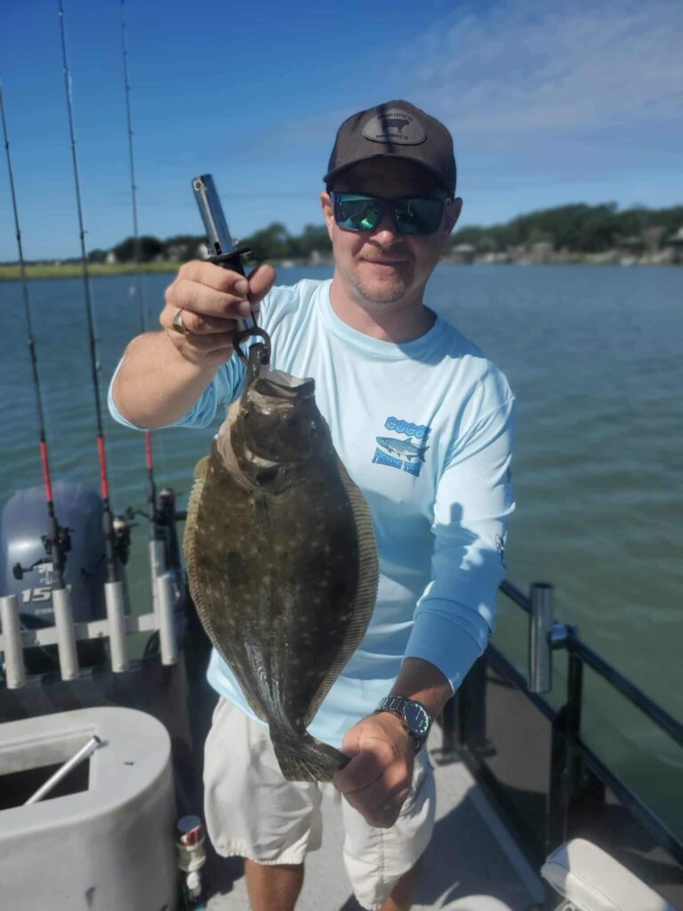 Angler holding a redfish during an inshore fishing charter in Murrells Inlet South Carolina
