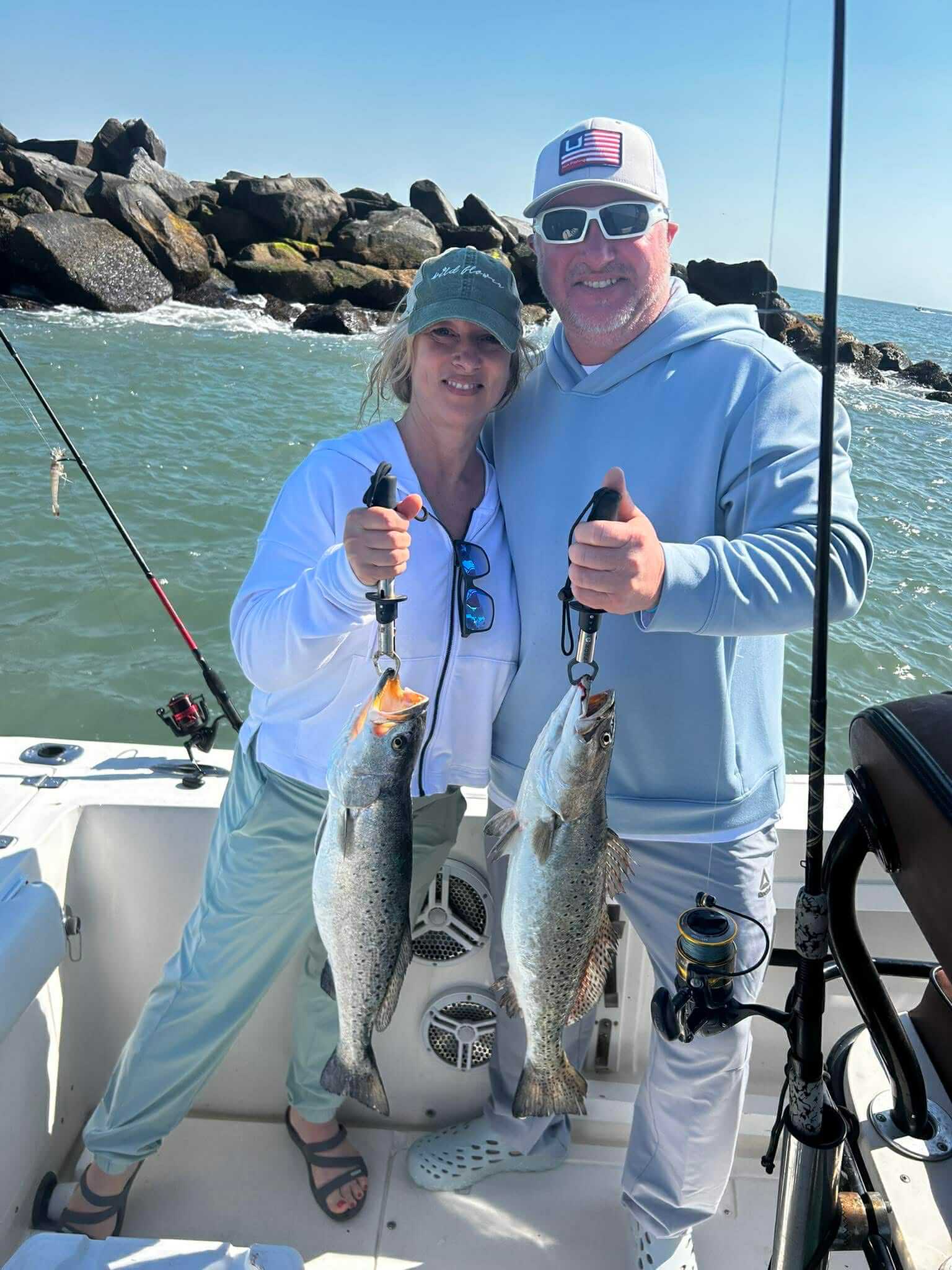 Anglers holding weakfish on an inshore fishing charter in Murrells Inlet near Myrtle Beach
