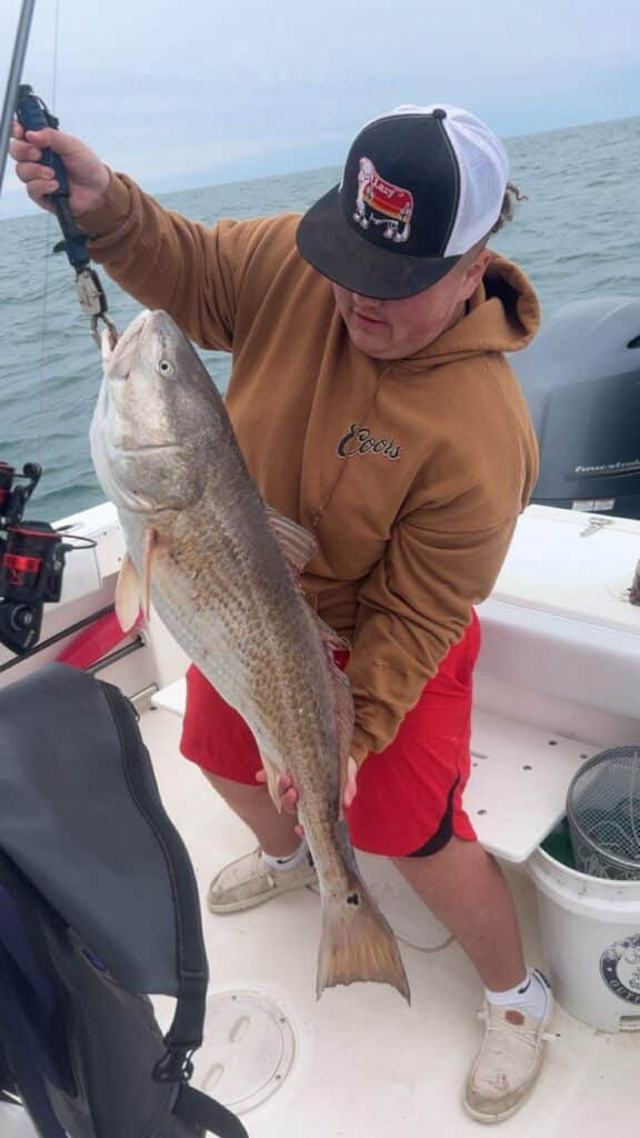 kid in Carhartt, bull redfish