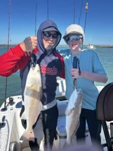 dad and kid, double redfish