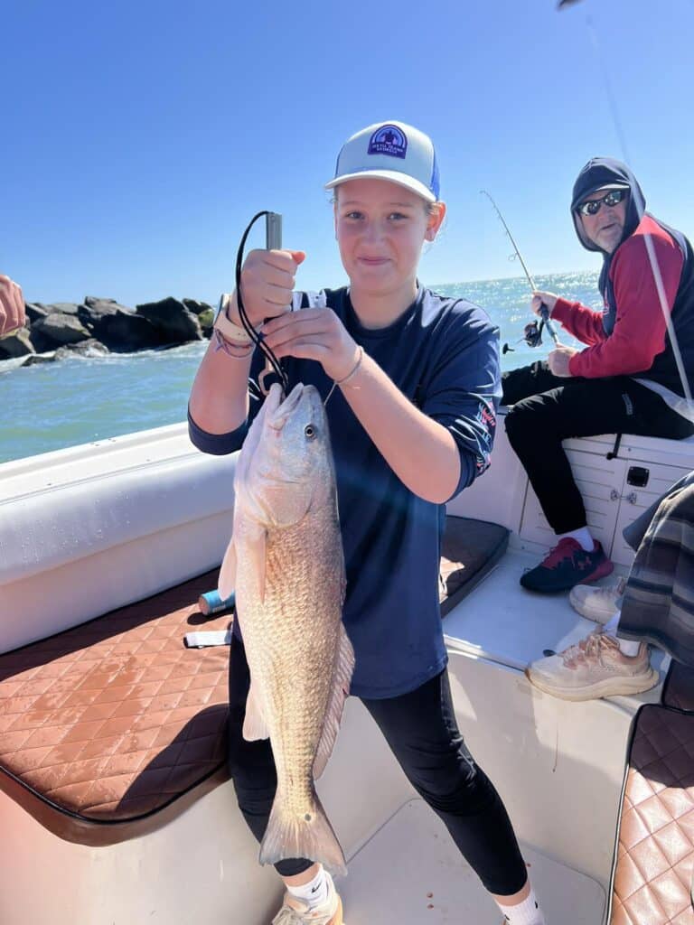girl with big red, jetty rocks