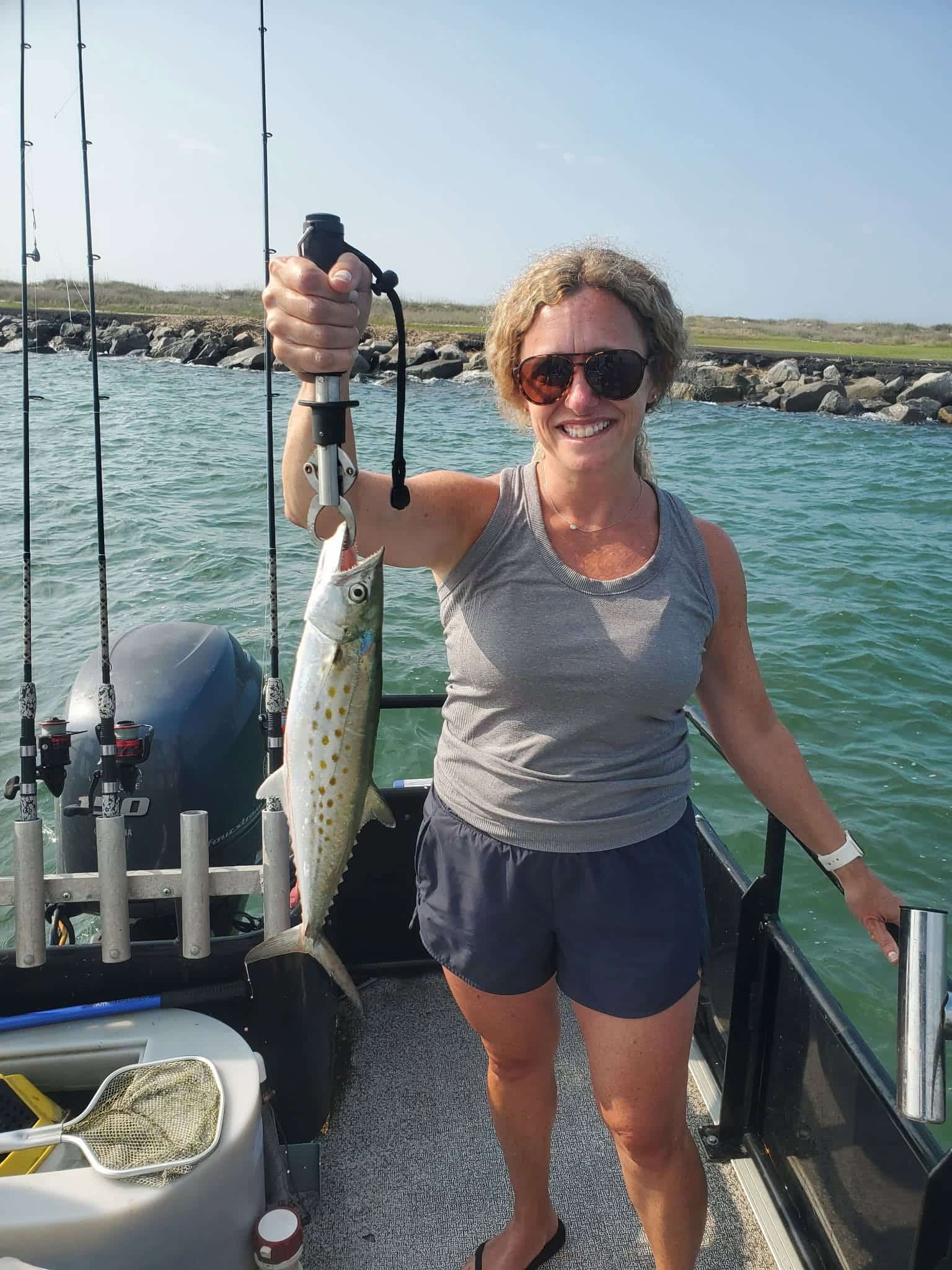Angler holding a Spanish mackerel on a fishing boat near Murrells Inlet